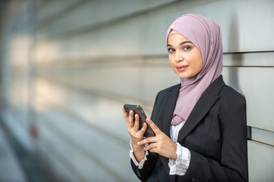 Portrait of young woman using mobile phone