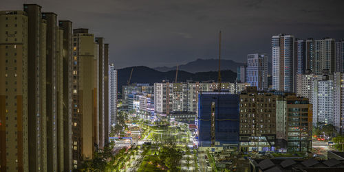 High angle view of illuminated buildings against sky at dusk