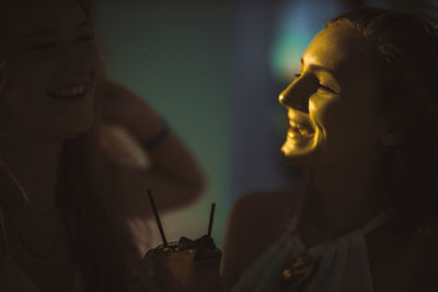 Close-up of female friends having drink outdoors