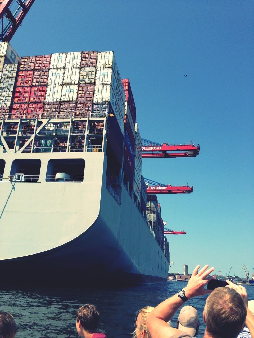 clear sky, lifestyles, leisure activity, men, blue, built structure, architecture, building exterior, copy space, person, nautical vessel, water, transportation, sitting, boat, sea, day, travel