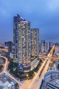 High angle view of illuminated buildings in city against sky