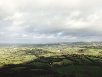 Aerial view of agricultural field against sky