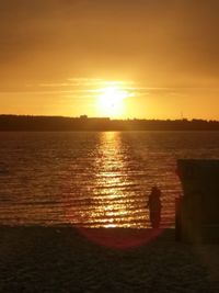 Scenic view of sea against orange sky