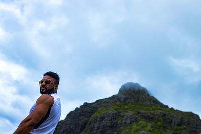 Low angle view of man standing against sky