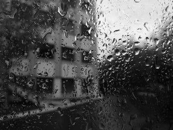 Close-up of wet glass window in rainy season