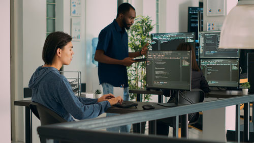 Rear view of business colleagues working at office