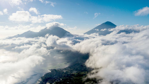 Scenic view of clouds over mountains against sky