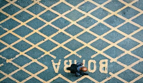 High angle view of man walking on street