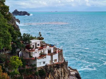 High angle view of buildings by sea against sky