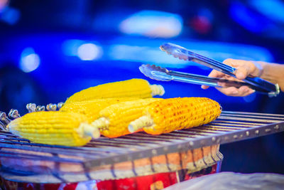 Close-up of hand holding ice cream on table