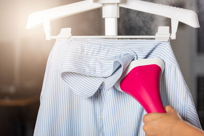 Midsection of woman holding exercise equipment