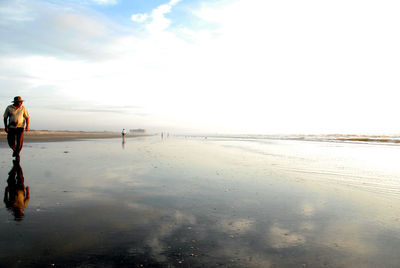 Woman on beach against sky