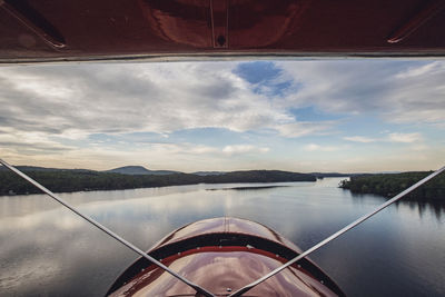 View from cockpit of vintage plane as it flies over kezar lake in main