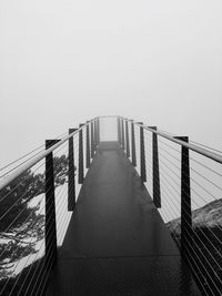 Footbridge against clear sky