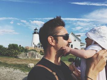 Side view of mid adult man playing with toddler child