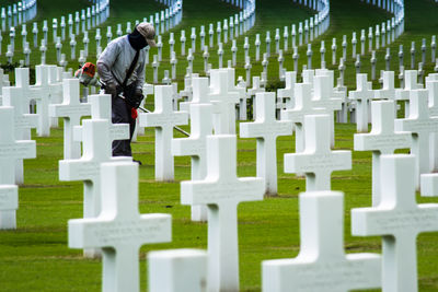 Male worker cleaning cemetery