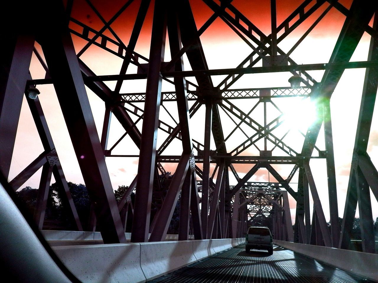 built structure, bridge - man made structure, architecture, connection, indoors, engineering, transportation, metal, diminishing perspective, low angle view, the way forward, sunlight, railing, metallic, sky, bridge, sunbeam, vanishing point, no people, sun