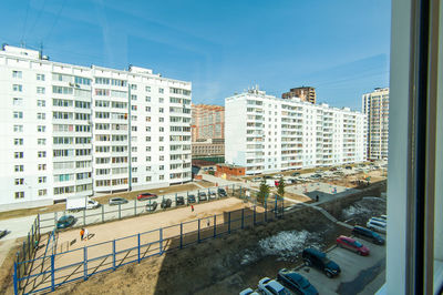 High angle view of buildings in city against sky