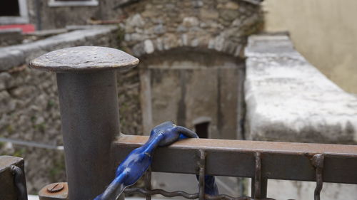 Close-up of metal railing against wall in yard