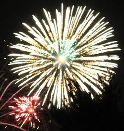 Low angle view of firework display at night