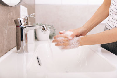 High angle view of man washing hands in sink