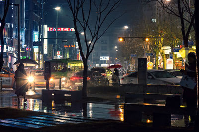 Illuminated city street at night