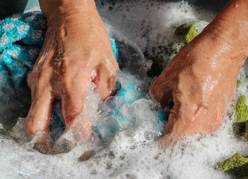 Close-up of hands washing clothes