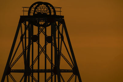 Low angle view of silhouette built structure against sky