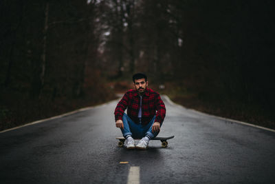 Portrait of man riding motorcycle on road