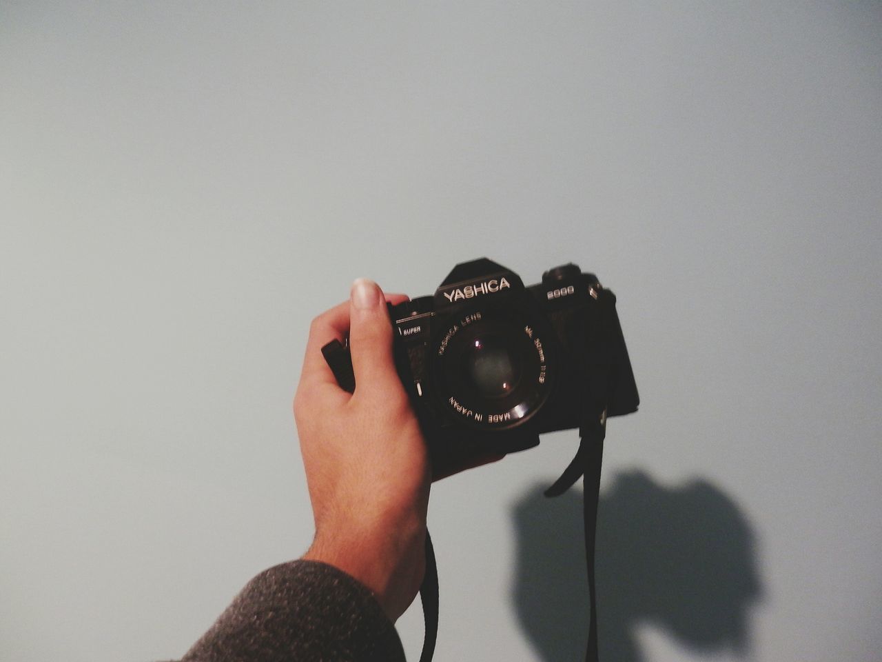 person, holding, part of, copy space, human finger, cropped, close-up, lifestyles, unrecognizable person, personal perspective, leisure activity, white background, studio shot, indoors, men, focus on foreground