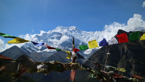 Low angle view of snowcapped mountains against sky