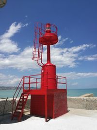 Lifeguard hut on beach against sky