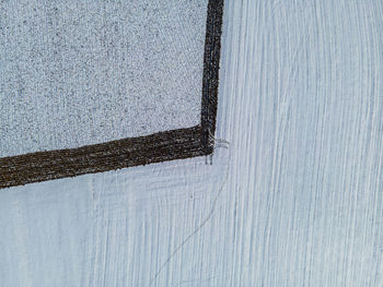 High angle view of snow on wood against wall