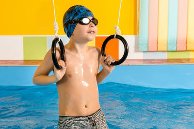 Shirtless boy in swimming pool