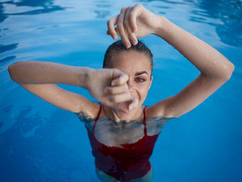 High angle portrait of woman swimming in pool