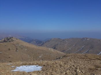 Scenic view of mountains against clear blue sky