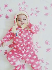 Portrait of cute baby girl on bed
