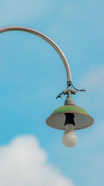 Low angle view of lighting equipment against sky