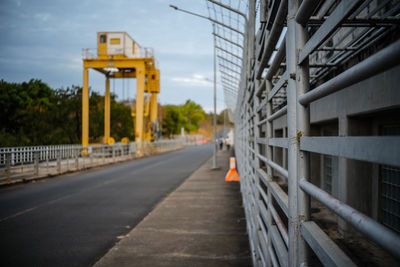 Bridge over road in city against sky