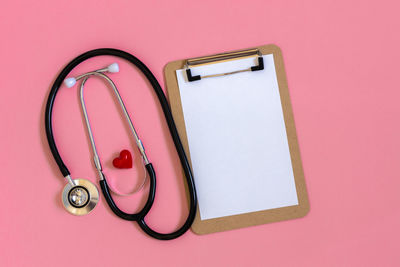 Close-up of stethoscope against yellow background