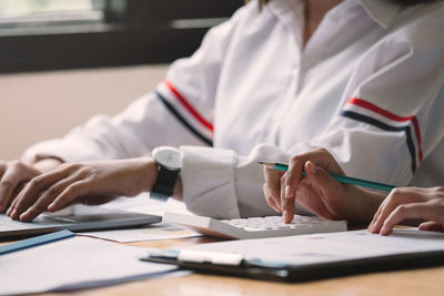 Midsection of woman working on table