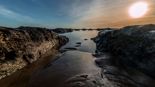 Scenic view of rocks against sky during sunset