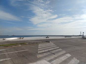 Airplane on runway against sky