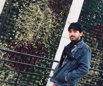 Portrait of man standing against plants