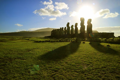 Silhouette of moai statues against dazzling sunrise sky at ahu tongariki, easter island, chile
