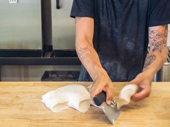 Midsection of man preparing food on table