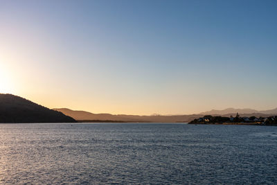 Scenic view of sea against clear sky during sunset