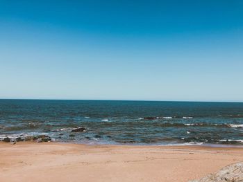 Scenic view of sea against clear blue sky