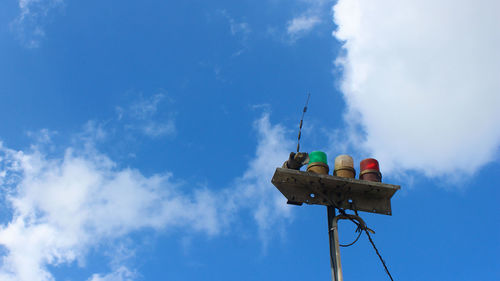 Low angle view of communications tower against blue sky