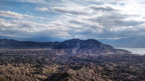 Scenic view of landscape against cloudy sky